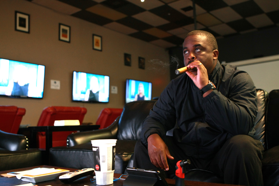 Windsor Hills resident John Coleman uses Smo King’s Fine Cigars as a place to work, relax, watch sports and socialize. Photo by Jason Lewis